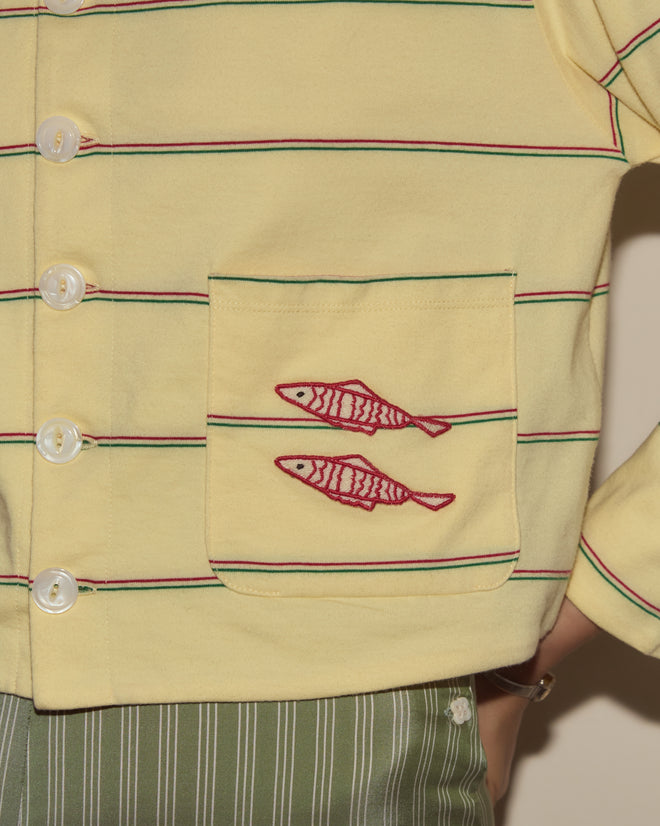Summertime Stripe Cardigan featuring yellow stripes, white buttons, and a pocket with two red fish appliqué, paired with green striped pants.