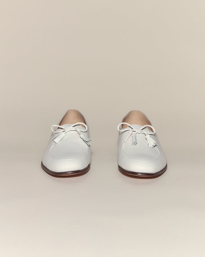 Tassel Shoes - White: White leather shoes with tasseled ties and a lace-up design, shown on a neutral background.