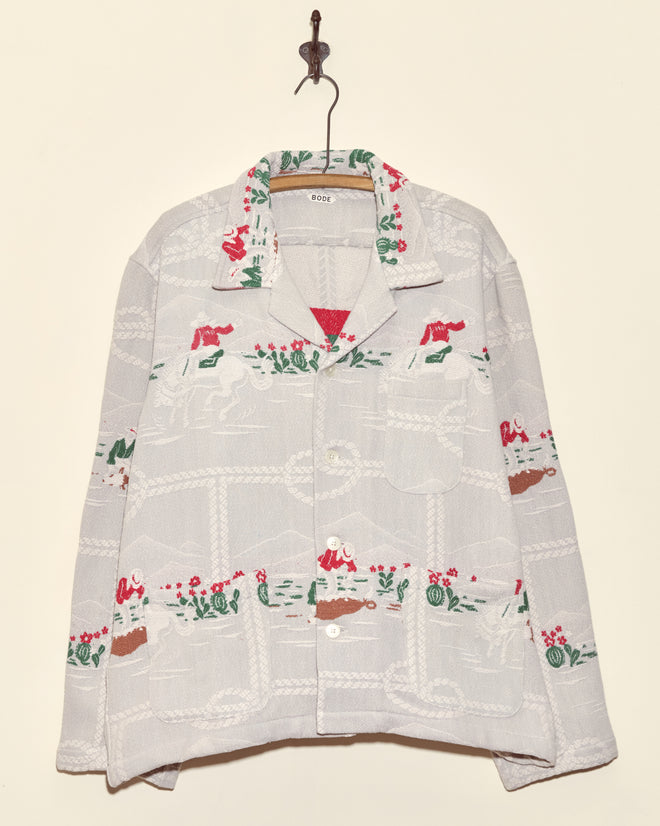 Team Ropers Overshirt - XL: White vintage cowboy button-up with red, green, and brown embroidered patterns, hanging on a hook.