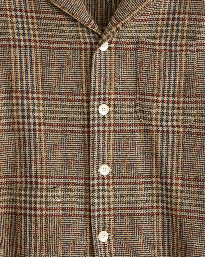 A Teatime Plaid Long Sleeve Shirt is displayed on a hanger against a tiled wall.