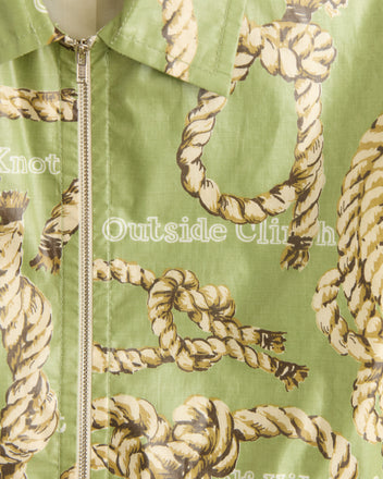 Close-up of the Topsail Rope Jacket made from green chintz fabric with sailor's knot patterns, featuring a vertical zipper and pointed collar.