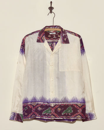 The Turaco Silk Shirt - L/XL is a unique long-sleeve silk shirt with purple and green geometric patterns on white, expertly crafted in New York.