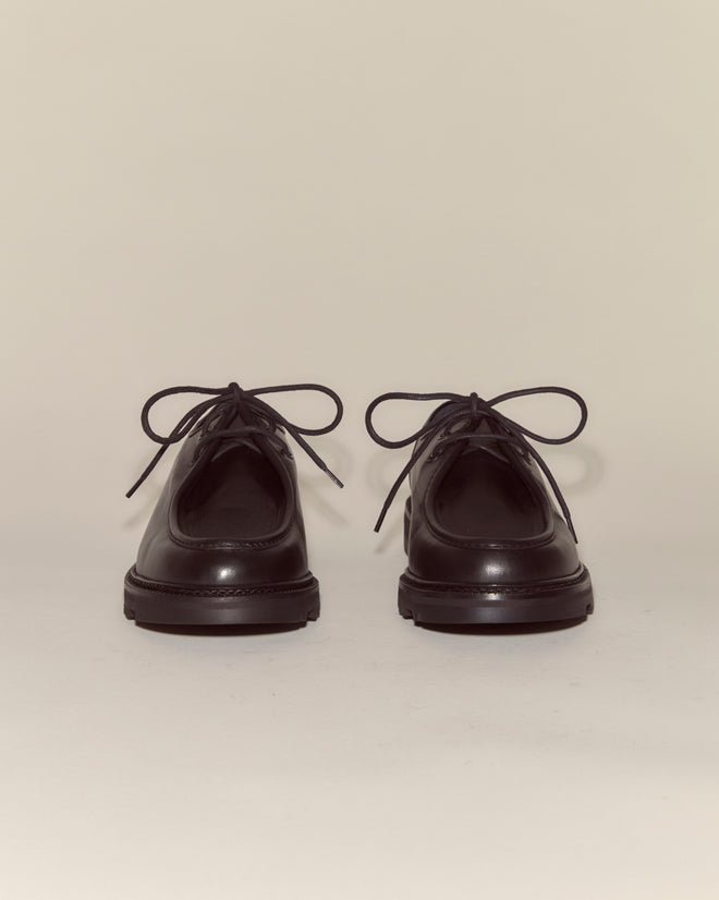 A pair of University Shoes - Black in Napa leather, lace-up style, positioned facing forward on a plain light background.