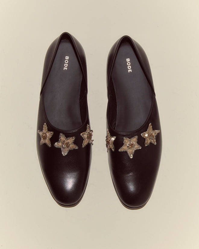 A top view of the Bullion Star Shoes: a pair of black Napa leather shoes with sequined stars on the toes.