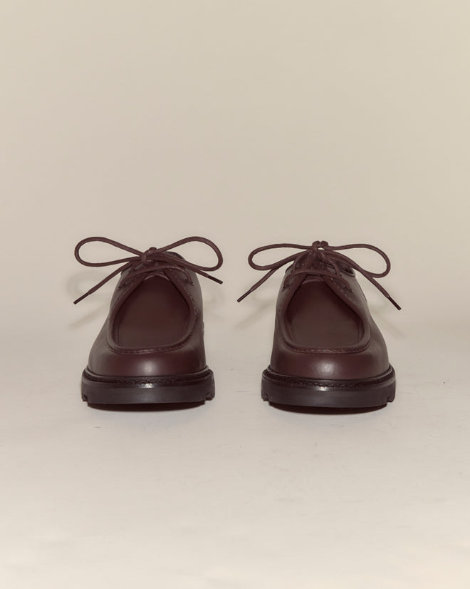A pair of University Shoes - Brown in dark brown calf leather are laced up and facing forward on a neutral background.
