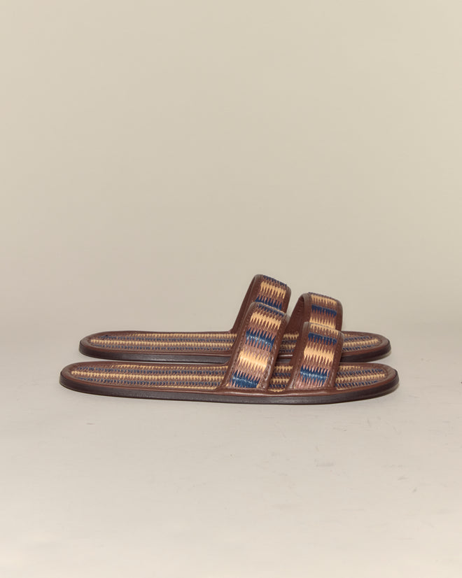 A pair of Duotone Summer Slides - Brown/Blue, featuring woven brown sandals with blue and tan accents, displayed side by side on a plain background.