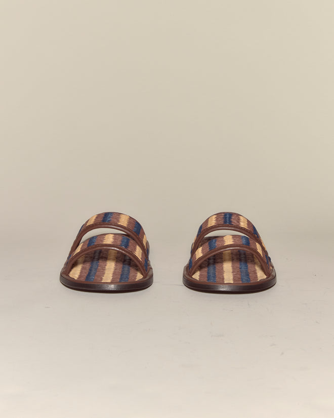 The Duotone Summer Slides - Brown/Blue feature brown, tan, and blue stripes in a raffia leather style, shown from the front against a plain background.