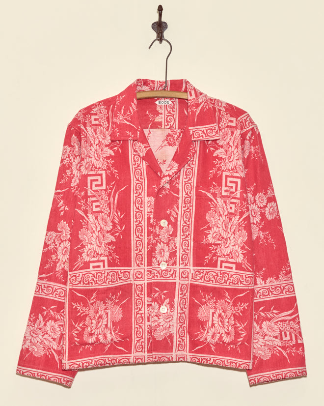 Unique Victoria Daisy Long Sleeve Shirt in red with white floral and geometric damask patterns, button-up, size M, displayed on a hanger against a beige wall.
