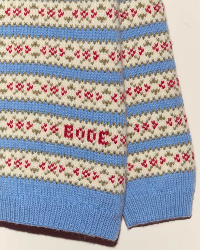 The Wedgewood Sweater features vintage knitwear with blue, white, olive, and red patterns and "EDGE" stitched in red.