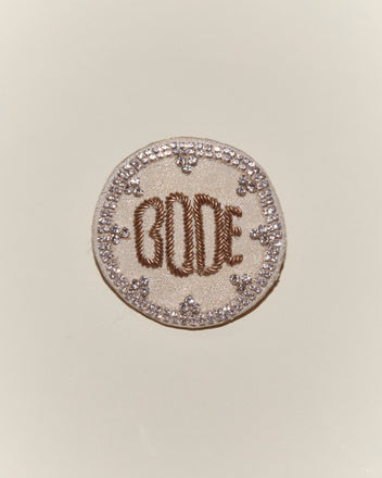 The Willow Brooch - White is a round embroidered accessory inspired by Bode, featuring 