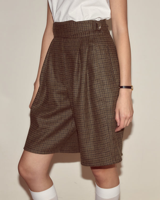 Person wearing Morris Houndstooth Shorts with D-ring waist adjusters, a white t-shirt, white knee socks, and a black wristwatch.