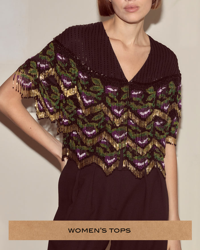 Back top covered in layered strands of glass seed beads, worked in a dark purple, green and gold floral pattern
