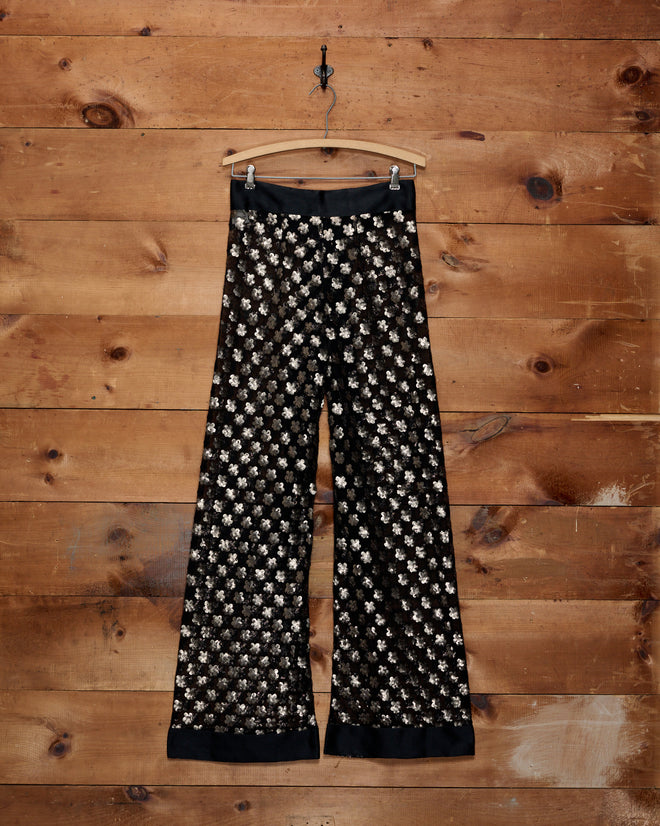 Pyrite Sequin Pants: black wide-leg trousers covered in bronze floral sequins with a wide ribbon tie.