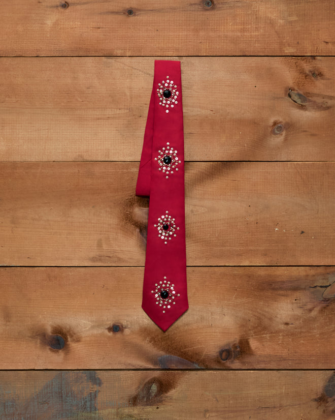 Luminaire Tie: red necktie with four circular clusters of silver sequins, bullion embroidery, and black stones.