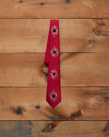 Luminaire Tie: red necktie with four circular clusters of silver sequins, bullion embroidery, and black stones.