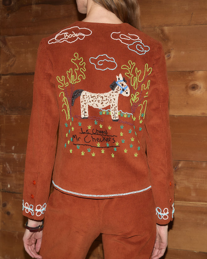 Brown Cheval Corduroy jacket featuring back embroidery of a spotted horse, clouds, and text.