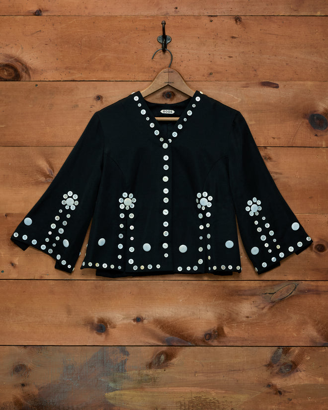 Pearly Royal Overshirt: black V-neck, three-quarter sleeve jacket with floral-patterned pearl buttons.