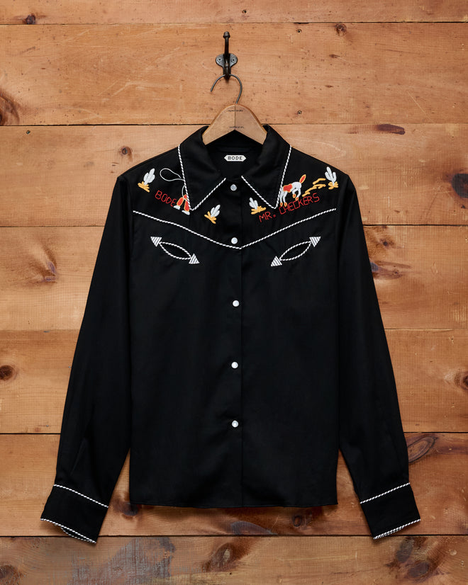 Bring a retro twist to your child’s wardrobe with the Checkers Western Blouse—a 1950s-inspired black shirt featuring classic white piping, embroidered birds and arrows, plus “Rock n’ Roll Forever” on the chest. Perfect for little cowboys and pint-sized rockers!.