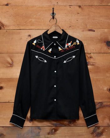 Bring a retro twist to your child’s wardrobe with the Checkers Western Blouse—a 1950s-inspired black shirt featuring classic white piping, embroidered birds and arrows, plus “Rock n’ Roll Forever” on the chest. Perfect for little cowboys and pint-sized rockers!.