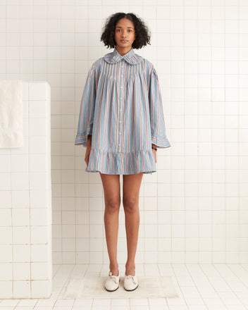 Individual wearing a Regatta Stripe Dress stands on a tiled floor in a bathroom setting.