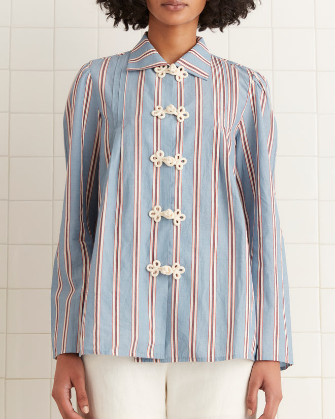 Someone wearing the Regatta Stripe Jonas Shirt with decorative buttons, standing against a tiled wall.