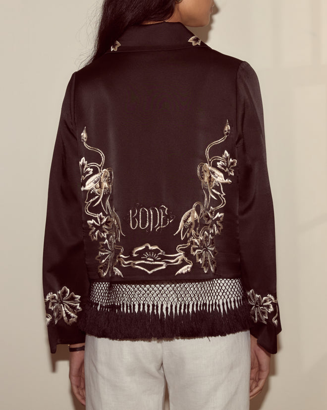 Wearing the Phantasm Fringe Jacket - Black, featuring black silk satin, floral Victorian embroidery, and "LOVE" embroidered on the back.