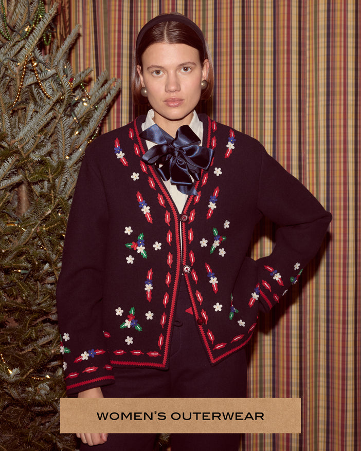 A female model wearing a felted jacket in front of a Christmas tree and a plaid curtain.