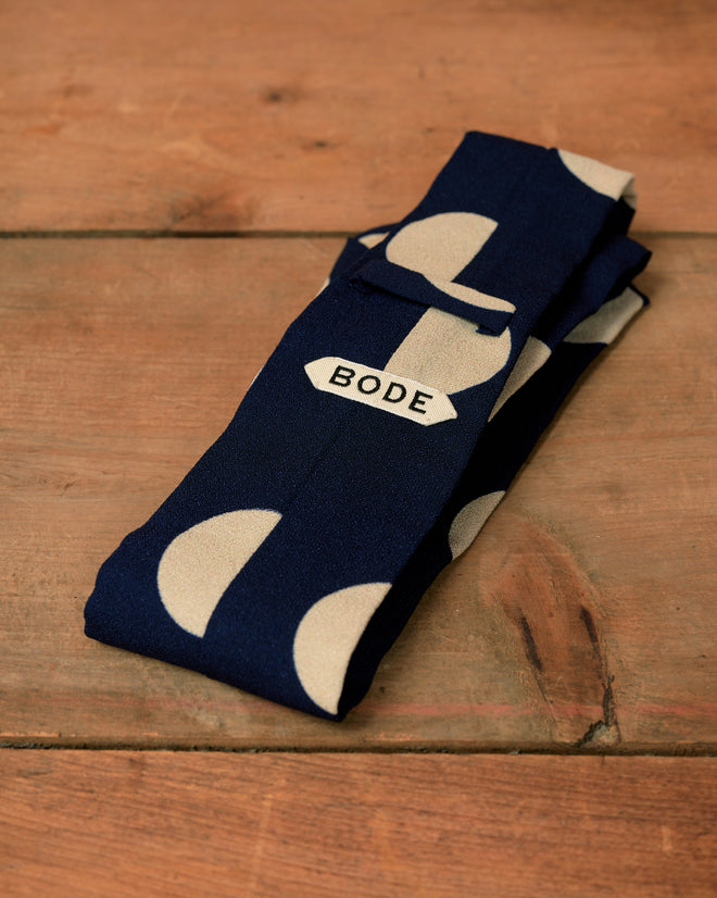 Navy blue Dot Crêpe Neck Tie with a repeating light-colored half-circle pattern and a white brand label.