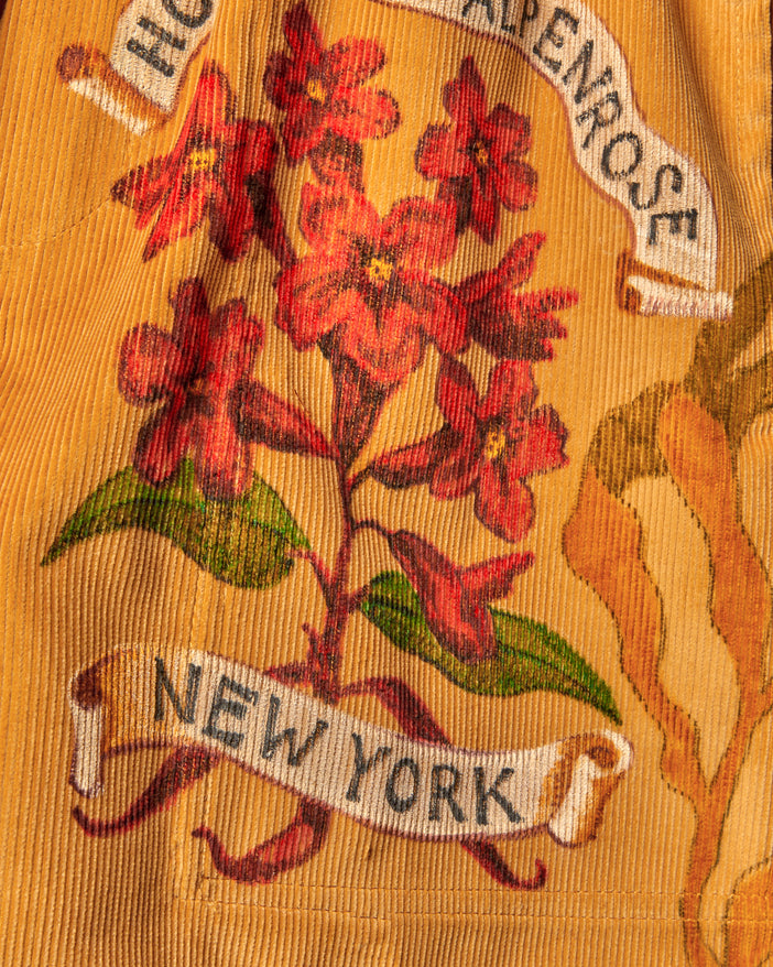 corn-colored British corduroy with hand-drawn illustrations in color of a floral motif with 
