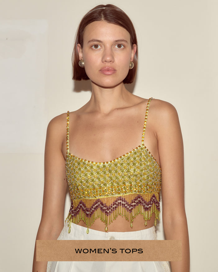 Model wearing a chartreuse and purple beaded top.